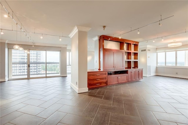 2510 Grand Blvd Unit 2502-03, Kansas City, MO 64108 - unfurnished living room with track lighting and ornamental molding