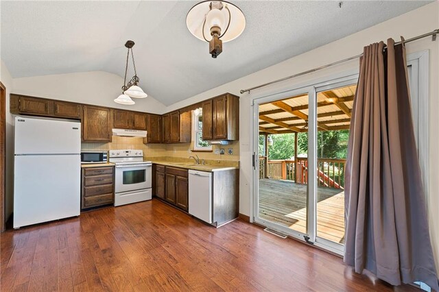 19308 E 18th St N, Independence, MO 64058 - kitchen with white appliances, under cabinet range hood, light countertops, vaulted ceiling, and dark wood finished floors