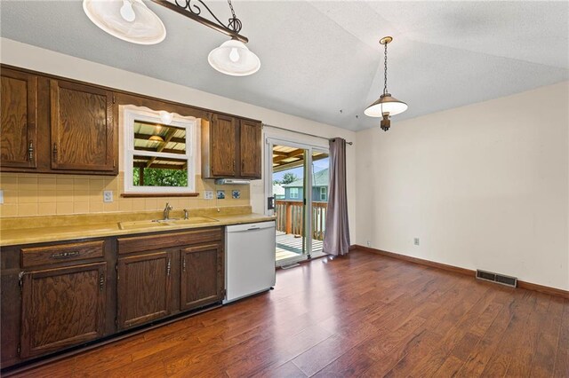 19308 E 18th St N, Independence, MO 64058 - kitchen featuring white dishwasher, dark wood-style floors, tasteful backsplash, light countertops, and vaulted ceiling
