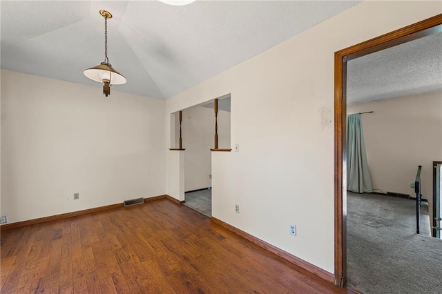 19308 E 18th St N, Independence, MO 64058 - spare room featuring wood finished floors, a textured ceiling, and lofted ceiling