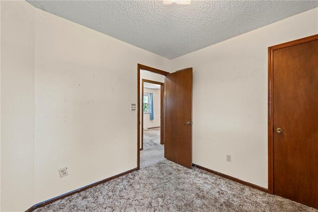 19308 E 18th St N, Independence, MO 64058 - spare room featuring light carpet and a textured ceiling