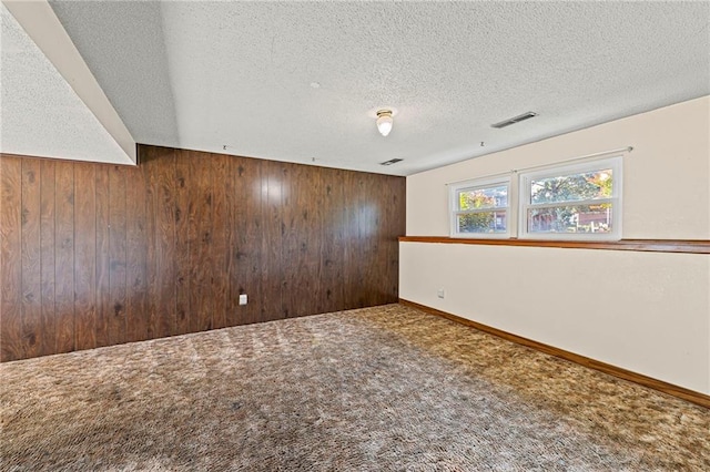 19308 E 18th St N, Independence, MO 64058 - carpeted spare room with wooden walls and a textured ceiling