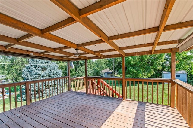 19308 E 18th St N, Independence, MO 64058 - wooden deck featuring a lawn, a storage unit, and view of wooded area