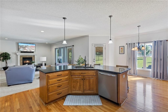 2712 SW Carlton Dr, Lees Summit, MO 64082 - kitchen with stainless steel dishwasher, light wood-style flooring, dark countertops, a textured ceiling, and open floor plan
