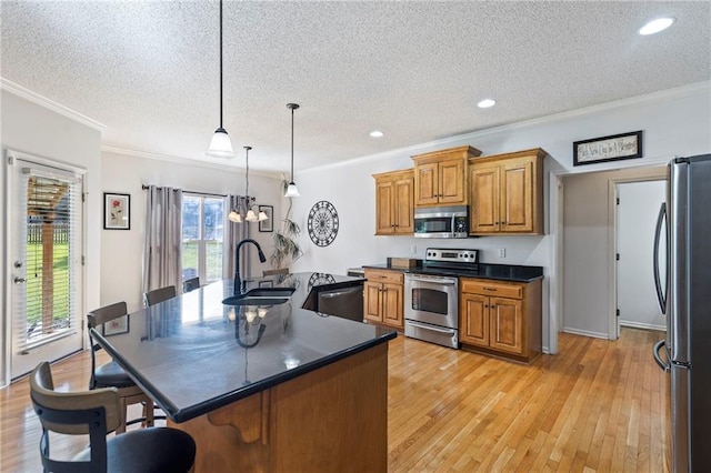 2712 SW Carlton Dr, Lees Summit, MO 64082 - kitchen with stainless steel appliances, brown cabinetry, a textured ceiling, a breakfast bar area, and dark countertops