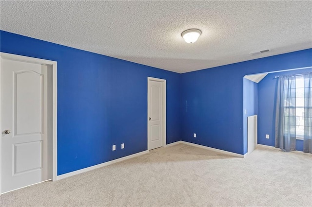 2712 SW Carlton Dr, Lees Summit, MO 64082 - carpeted spare room with a textured ceiling and baseboards