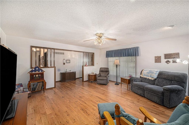 21830 155th St, Basehor, KS 66007 - living room with ceiling fan, light wood finished floors, and a textured ceiling