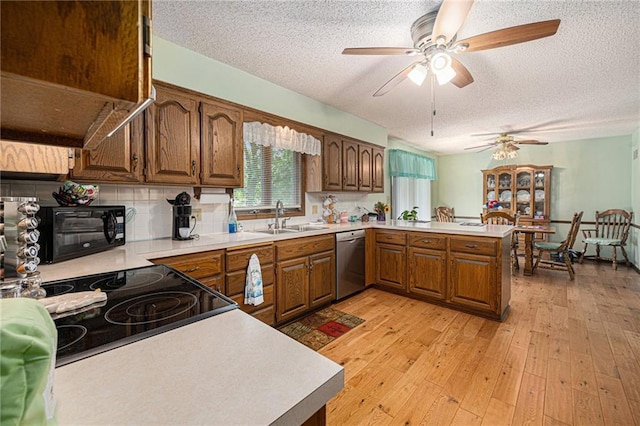 21830 155th St, Basehor, KS 66007 - kitchen with dishwasher, a peninsula, a textured ceiling, a ceiling fan, and light countertops