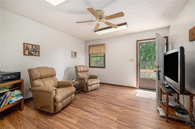 21830 155th St, Basehor, KS 66007 - sitting room featuring wood finished floors, a textured ceiling, plenty of natural light, and ceiling fan