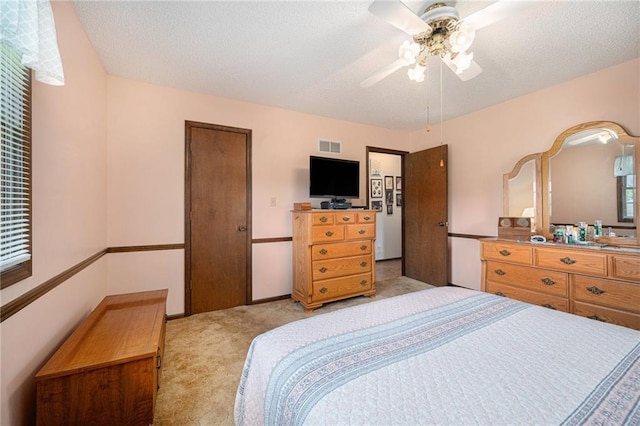 21830 155th St, Basehor, KS 66007 - bedroom with light colored carpet, ceiling fan, and a textured ceiling