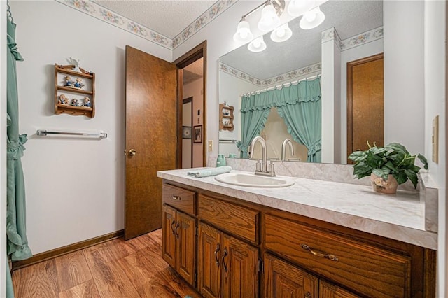 21830 155th St, Basehor, KS 66007 - full bath featuring vanity, a textured ceiling, and wood finished floors