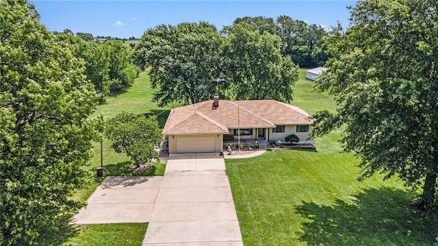 21830 155th St, Basehor, KS 66007 - view of front facade with a front yard, an attached garage, concrete driveway, and a chimney