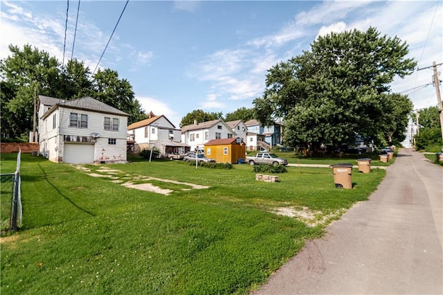 1134 Atchison St, Atchison, KS 66002 - view of grassy yard with an attached garage and a residential view