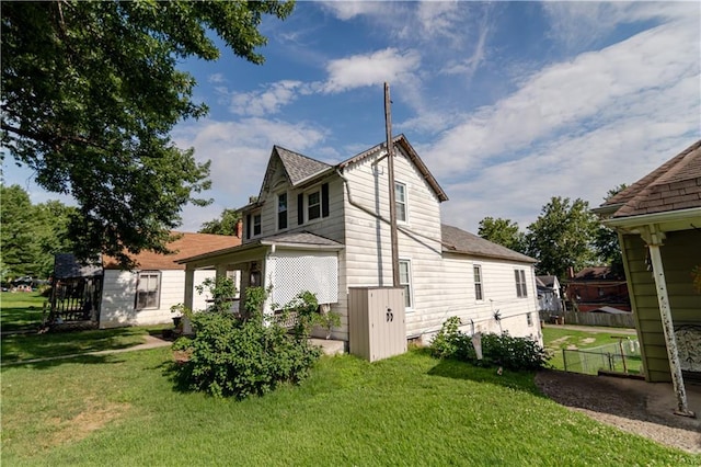 1134 Atchison St, Atchison, KS 66002 - view of side of property featuring a shingled roof