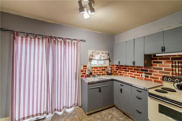 1134 Atchison St, Atchison, KS 66002 - kitchen with electric stove, gray cabinets, and light countertops