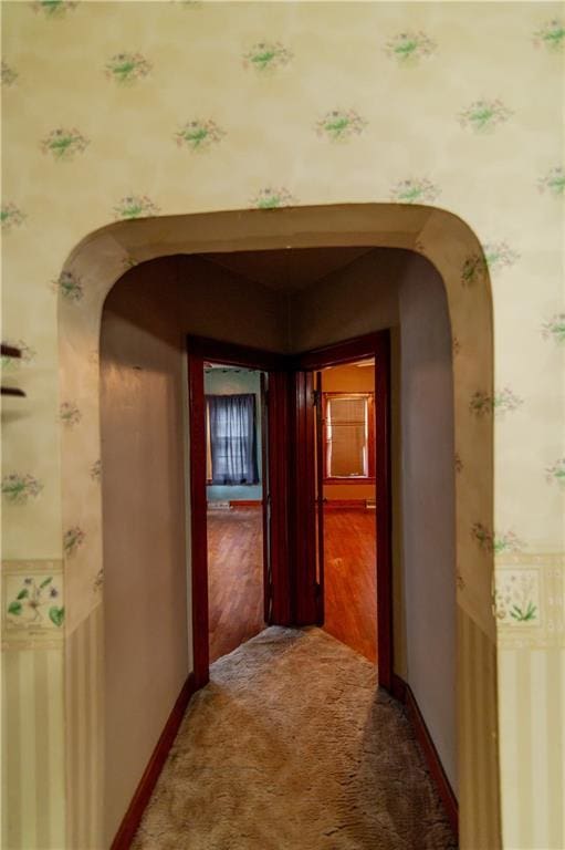 1134 Atchison St, Atchison, KS 66002 - hallway with arched walkways, carpet, and wallpapered walls