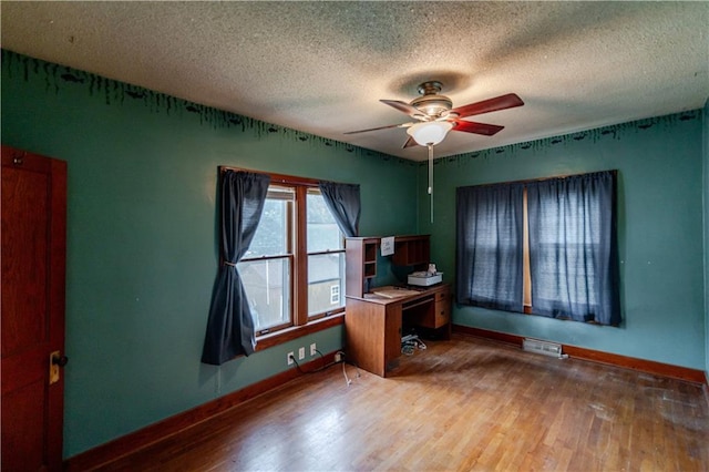 1134 Atchison St, Atchison, KS 66002 - unfurnished office with wood finished floors, ceiling fan, and a textured ceiling