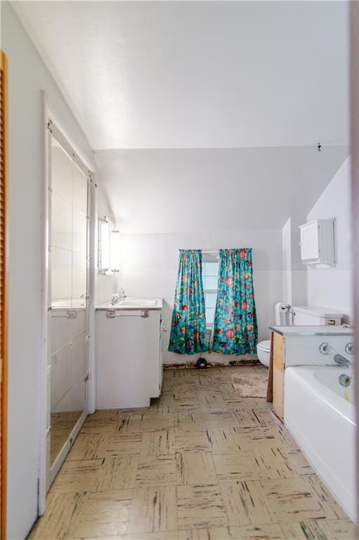 1134 Atchison St, Atchison, KS 66002 - full bathroom featuring lofted ceiling, tile patterned floors, a garden tub, a shower with door, and vanity