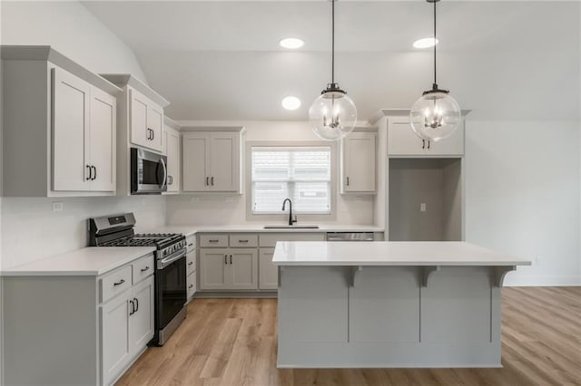 13491 Terrace Park Dr, Parkville, MO 64152 - kitchen featuring appliances with stainless steel finishes, tasteful backsplash, light wood-style flooring, light countertops, and a center island
