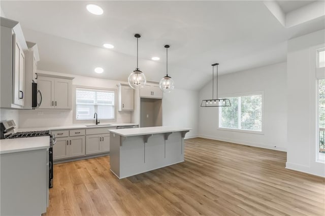 13491 Terrace Park Dr, Parkville, MO 64152 - kitchen featuring stainless steel appliances, light wood finished floors, recessed lighting, plenty of natural light, and light countertops