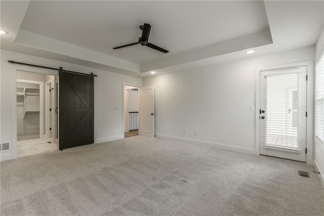 13491 Terrace Park Dr, Parkville, MO 64152 - unfurnished bedroom with a raised ceiling, recessed lighting, a barn door, carpet, and ceiling fan