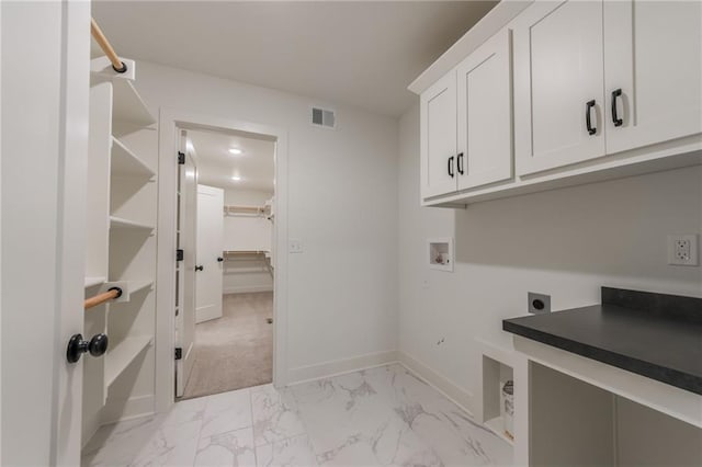 13491 Terrace Park Dr, Parkville, MO 64152 - laundry room with cabinet space, hookup for an electric dryer, hookup for a washing machine, and light marble finish floors