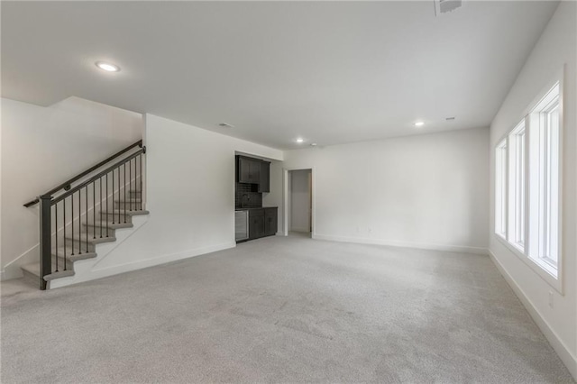 13491 Terrace Park Dr, Parkville, MO 64152 - unfurnished living room featuring light carpet, recessed lighting, and stairs