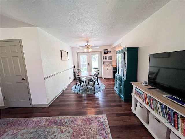 701 N Godfrey St, Cameron, MO 64429 - dining room featuring a textured ceiling, dark wood-type flooring, a ceiling fan, and french doors