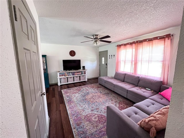 701 N Godfrey St, Cameron, MO 64429 - living area with a textured ceiling, a ceiling fan, and dark wood-type flooring
