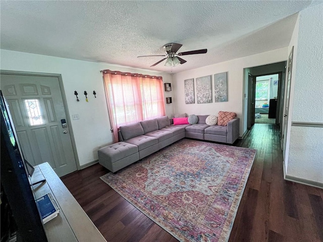 701 N Godfrey St, Cameron, MO 64429 - living area with a textured ceiling, dark wood-style flooring, and a ceiling fan
