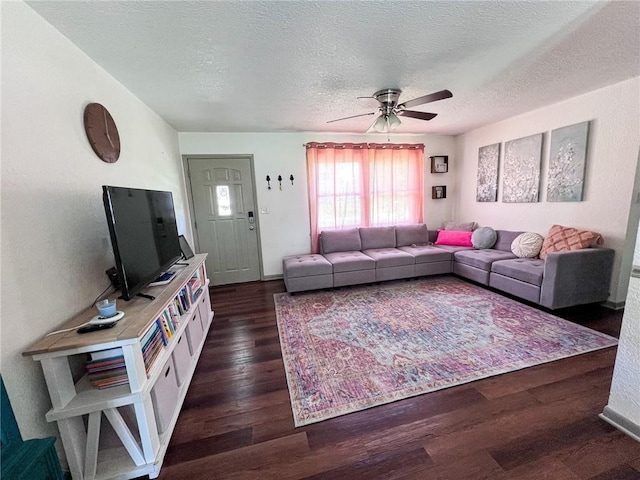 701 N Godfrey St, Cameron, MO 64429 - living room featuring a ceiling fan, a textured ceiling, and dark wood finished floors