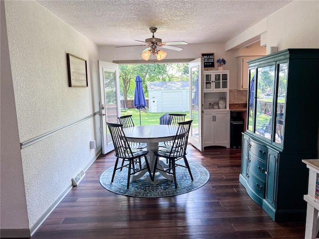 701 N Godfrey St, Cameron, MO 64429 - dining area with a textured wall, a textured ceiling, ceiling fan, and dark wood-type flooring