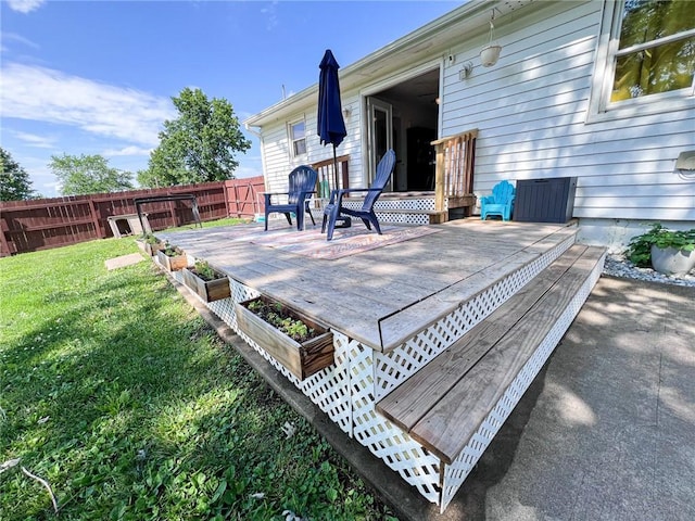 701 N Godfrey St, Cameron, MO 64429 - wooden deck with a vegetable garden