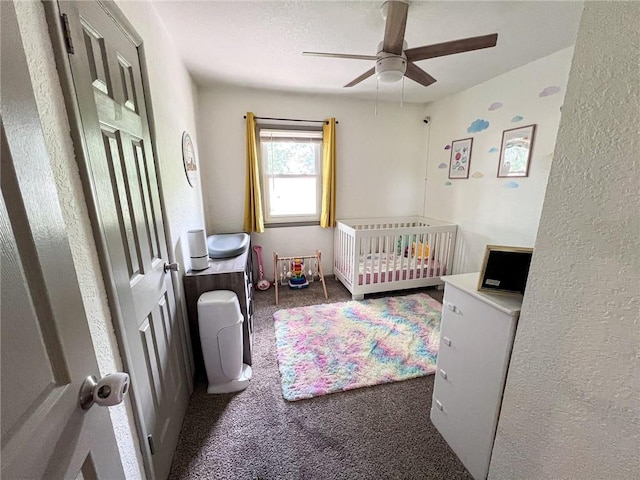 701 N Godfrey St, Cameron, MO 64429 - carpeted bedroom featuring a textured wall, a ceiling fan, and a crib