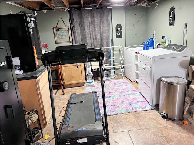 701 N Godfrey St, Cameron, MO 64429 - unfinished basement featuring independent washer and dryer and freestanding refrigerator