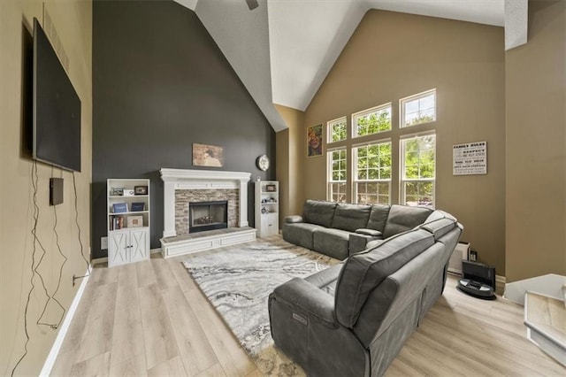 16122 W 157th St, Olathe, KS 66062 - living area featuring high vaulted ceiling, light wood finished floors, a fireplace, and ceiling fan