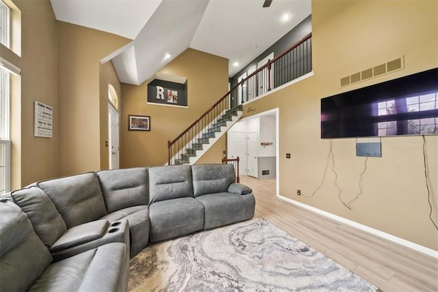 16122 W 157th St, Olathe, KS 66062 - living area featuring wood finished floors, a high ceiling, stairway, and recessed lighting