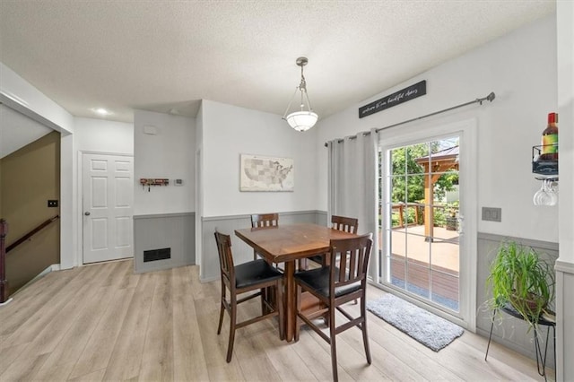 16122 W 157th St, Olathe, KS 66062 - dining room with a textured ceiling, light wood-style floors, and a wainscoted wall