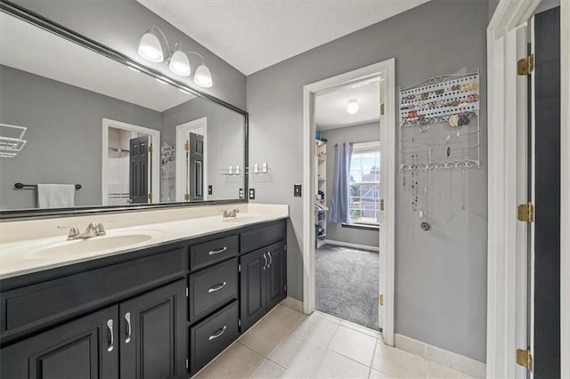 16122 W 157th St, Olathe, KS 66062 - bathroom featuring double vanity, walk in shower, tile patterned flooring, and a textured ceiling