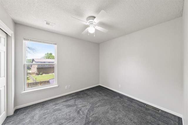 16122 W 157th St, Olathe, KS 66062 - empty room with dark colored carpet, ceiling fan, and a textured ceiling