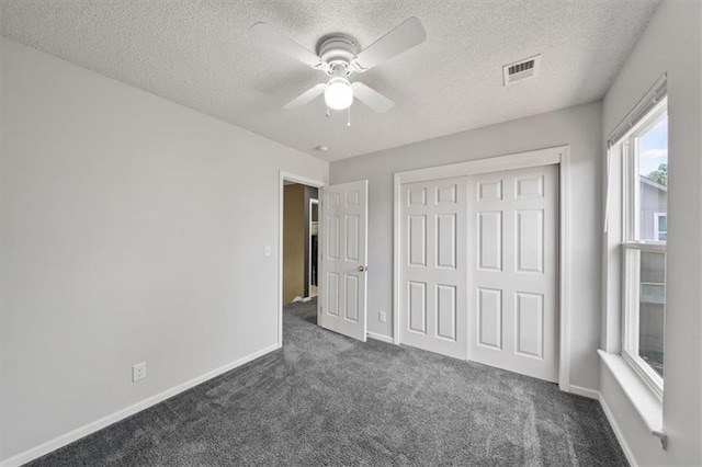 16122 W 157th St, Olathe, KS 66062 - unfurnished bedroom with dark carpet, a textured ceiling, a closet, and ceiling fan