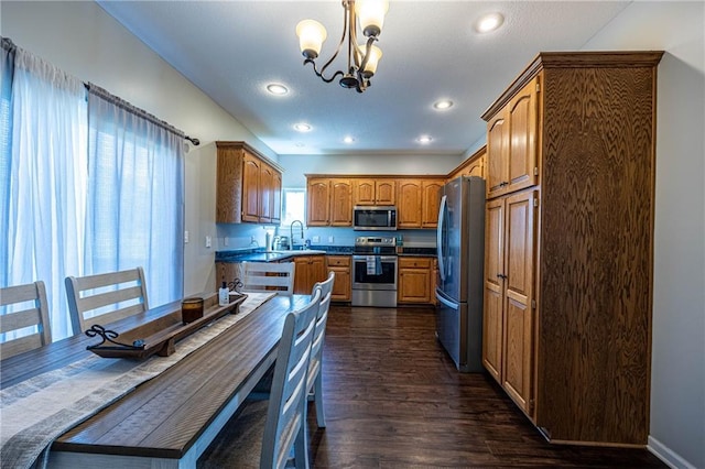61 SW 446th Rd, Clinton, MO 64735 - kitchen with stainless steel appliances, a chandelier, dark wood finished floors, brown cabinets, and recessed lighting