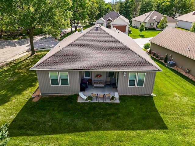 2214 SW 9th St, Blue Springs, MO 64014 - back of house with a shingled roof, a patio, a yard, board and batten siding, and a residential view