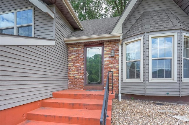 16327 W Locust St, Olathe, KS 66062 - doorway to property featuring brick siding and a shingled roof