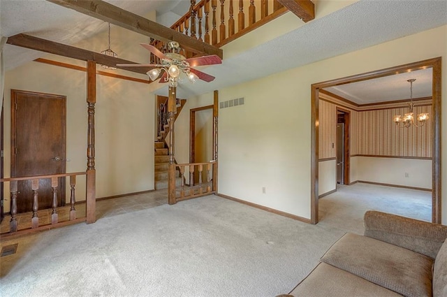 16327 W Locust St, Olathe, KS 66062 - unfurnished living room with carpet, a ceiling fan, a chandelier, and stairs