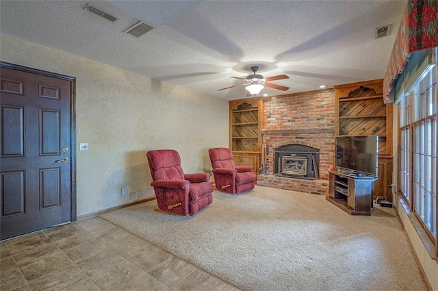 16327 W Locust St, Olathe, KS 66062 - living area featuring a ceiling fan, a textured ceiling, a fireplace, built in features, and carpet floors