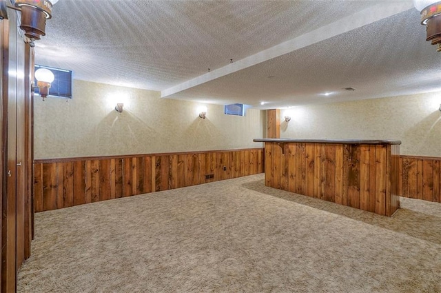 16327 W Locust St, Olathe, KS 66062 - finished below grade area with wood walls, a wainscoted wall, carpet floors, a bar, and a textured ceiling