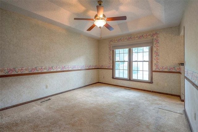 16327 W Locust St, Olathe, KS 66062 - carpeted spare room featuring ceiling fan, wallpapered walls, a textured ceiling, and a tray ceiling