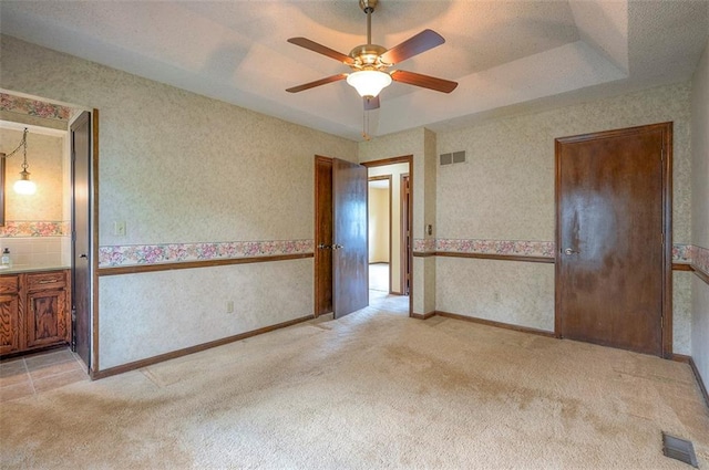 16327 W Locust St, Olathe, KS 66062 - spare room featuring light carpet, wallpapered walls, and a ceiling fan