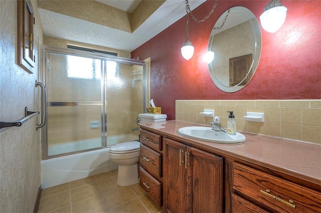 16327 W Locust St, Olathe, KS 66062 - bathroom with vanity, tile patterned floors, enclosed tub / shower combo, and a textured wall